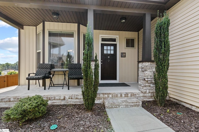 view of exterior entry featuring covered porch