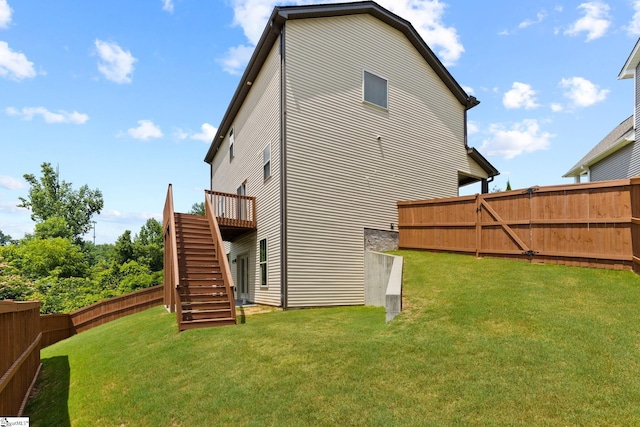 back of house with a yard and a wooden deck