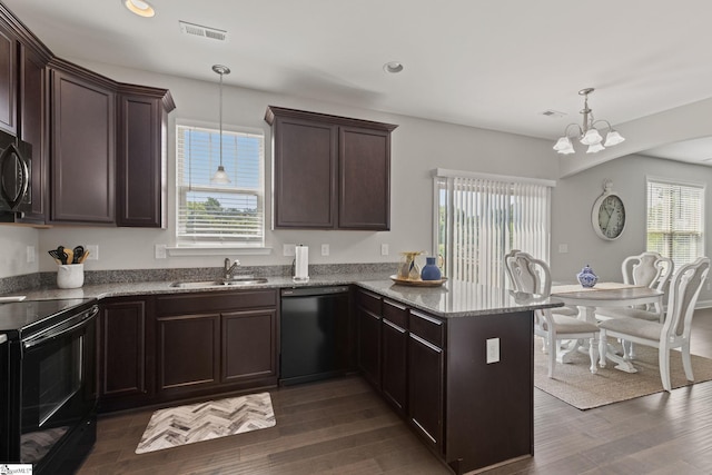 kitchen with pendant lighting, black appliances, sink, a notable chandelier, and kitchen peninsula