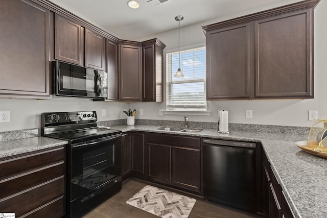 kitchen featuring sink, dark hardwood / wood-style flooring, decorative light fixtures, dark brown cabinets, and black appliances