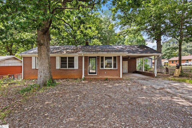 ranch-style home featuring a carport