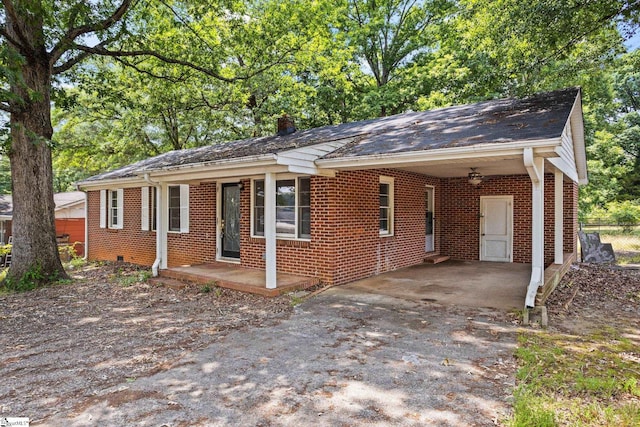 single story home featuring a carport