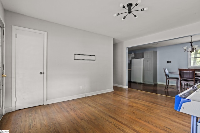 interior space with a notable chandelier and dark hardwood / wood-style floors