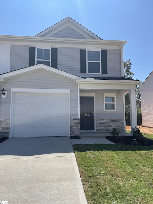 view of front of house featuring a garage, covered porch, and a front lawn