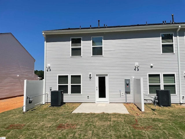 back of property featuring a patio, cooling unit, and a lawn