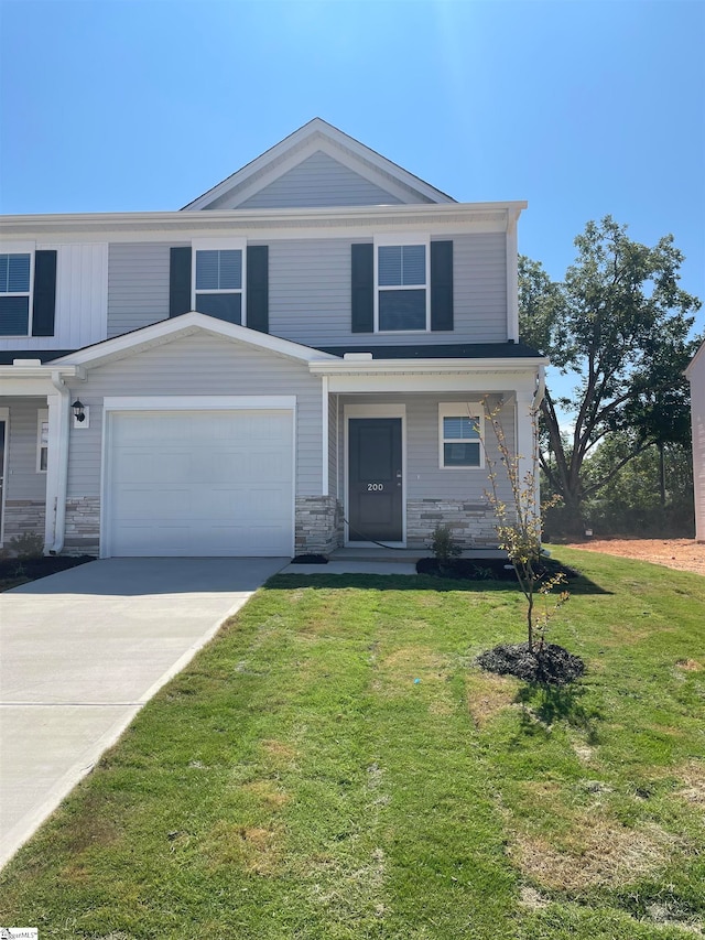 view of front of property with a garage and a front lawn