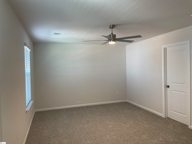 carpeted spare room with ceiling fan