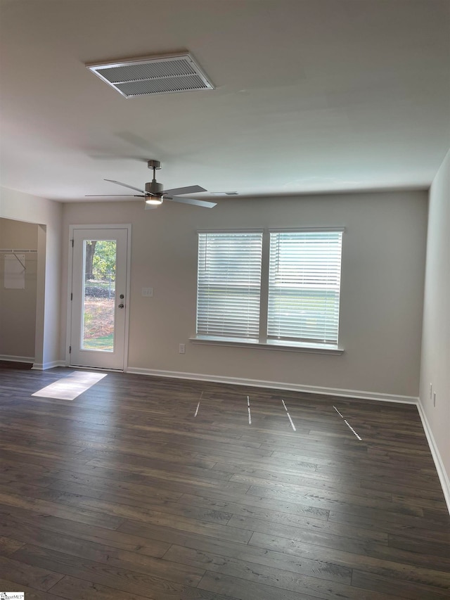 unfurnished room with ceiling fan and dark hardwood / wood-style floors