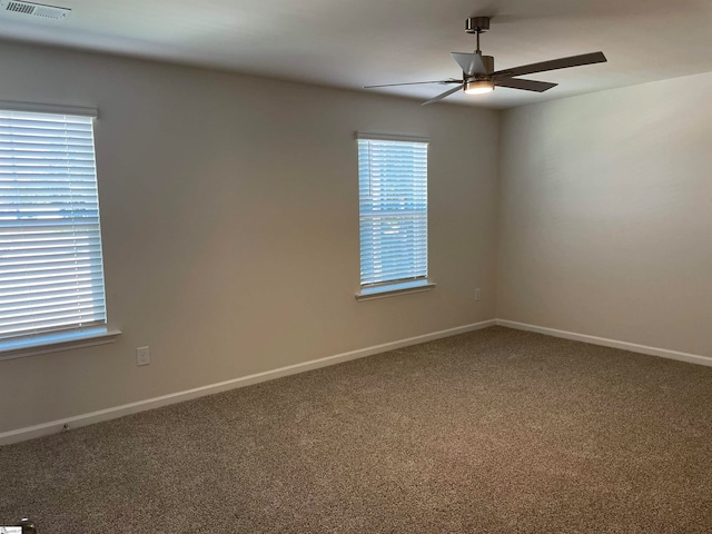 carpeted spare room with ceiling fan