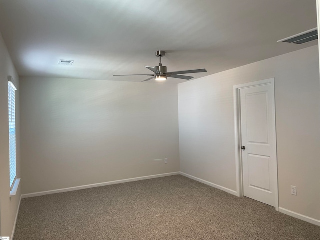 carpeted spare room with ceiling fan