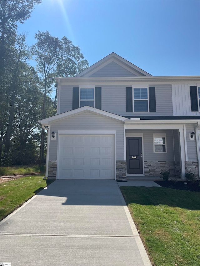 view of front of property featuring a front yard and a garage