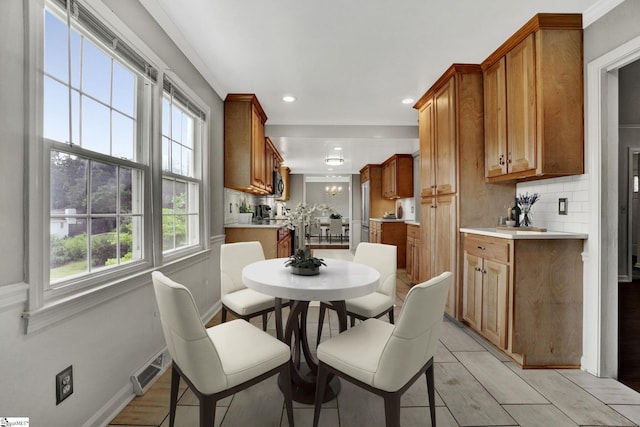 dining area featuring plenty of natural light, a chandelier, and light hardwood / wood-style flooring