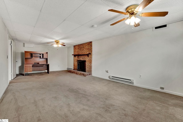 unfurnished living room with ceiling fan, light colored carpet, a brick fireplace, and a baseboard heating unit