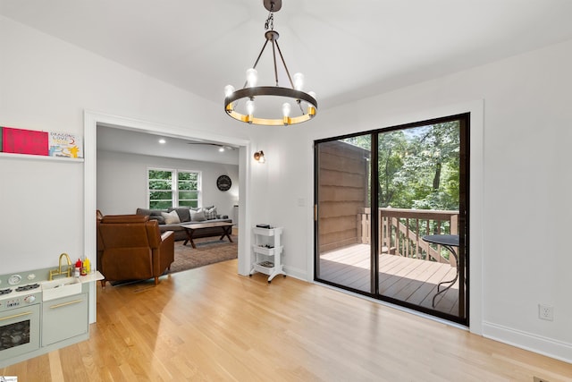 entryway featuring light hardwood / wood-style flooring and an inviting chandelier