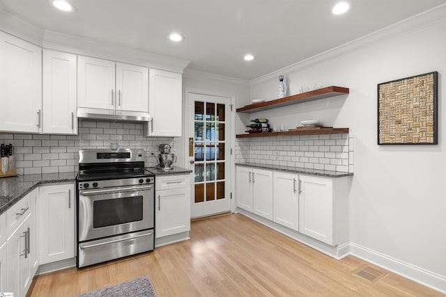 kitchen featuring white cabinets, decorative backsplash, light hardwood / wood-style floors, and stainless steel electric range oven