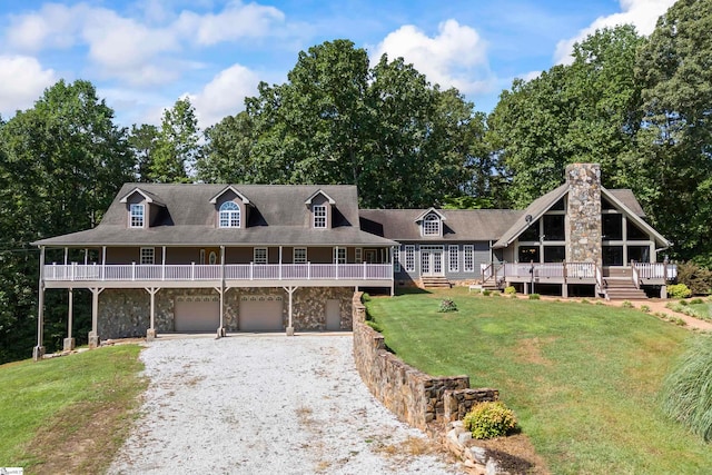 farmhouse-style home featuring a garage, a front yard, and a wooden deck