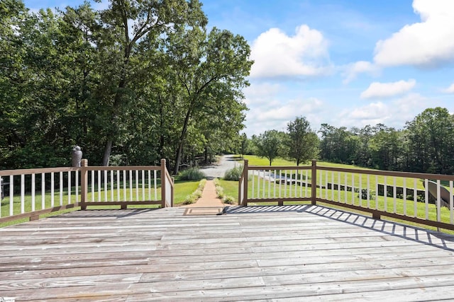 wooden terrace with a lawn