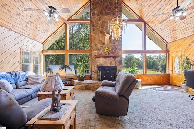 carpeted living room with ceiling fan with notable chandelier, wooden walls, high vaulted ceiling, and wooden ceiling