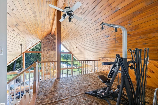 exercise area featuring wood walls, wooden ceiling, high vaulted ceiling, and ceiling fan