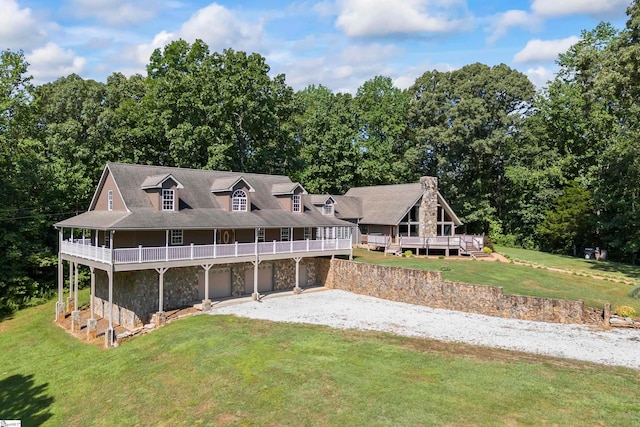 exterior space with a garage, a deck, and a yard