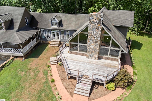 back of house featuring a wooden deck and a lawn