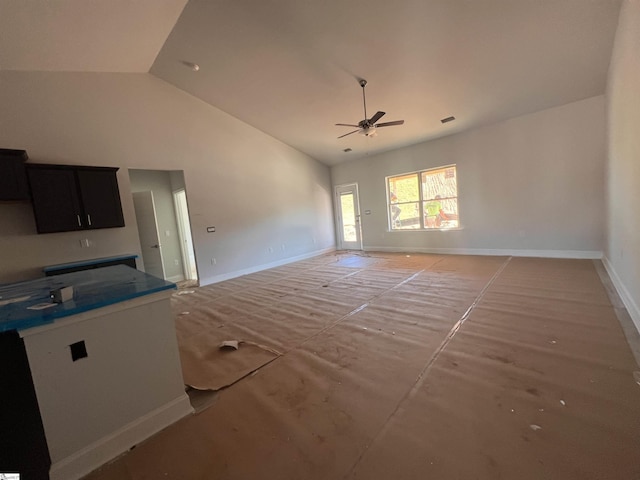 unfurnished living room featuring baseboards, high vaulted ceiling, visible vents, and a ceiling fan