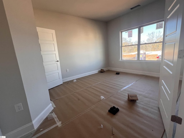 empty room featuring baseboards