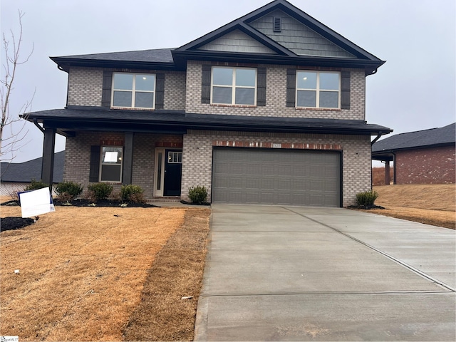 view of front of property featuring a garage and a front lawn