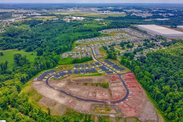 birds eye view of property with a wooded view