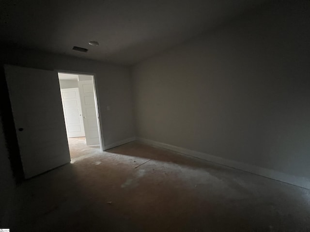 empty room featuring visible vents and baseboards