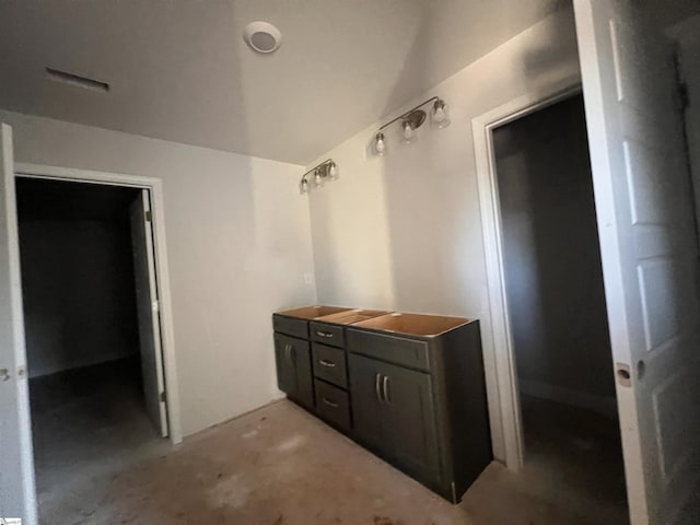 bathroom featuring unfinished concrete flooring