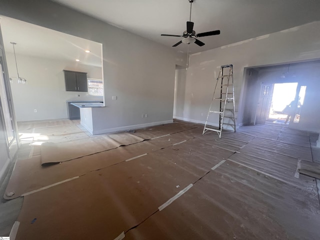 unfurnished living room featuring ceiling fan