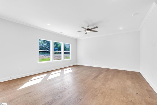 empty room with crown molding, light wood-type flooring, and ceiling fan