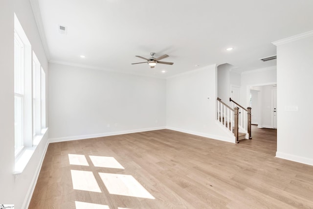 empty room featuring ceiling fan, crown molding, and light hardwood / wood-style flooring