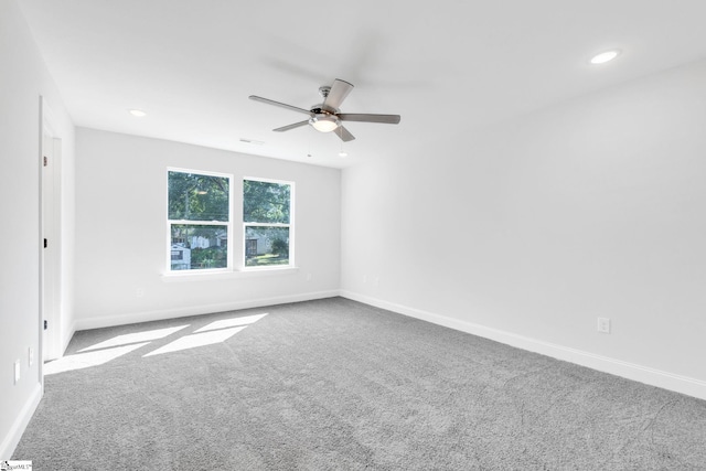 carpeted spare room featuring ceiling fan