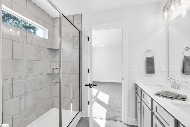 bathroom featuring an enclosed shower and dual bowl vanity