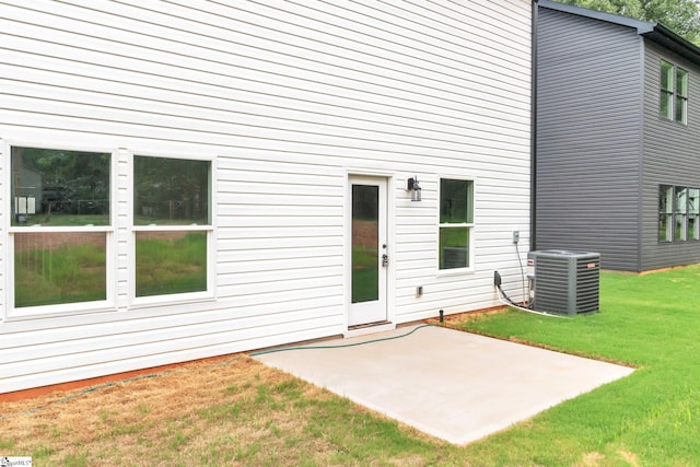 exterior space featuring a patio, a lawn, and cooling unit