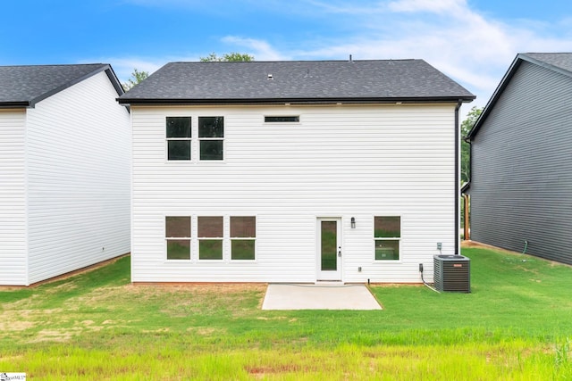 rear view of property with a patio, central air condition unit, and a lawn