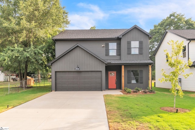 view of front of property with a garage and a front lawn