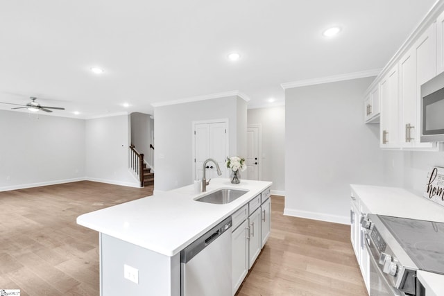 kitchen with ceiling fan, stainless steel appliances, an island with sink, sink, and light hardwood / wood-style floors