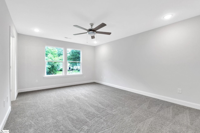 spare room featuring ceiling fan and carpet flooring