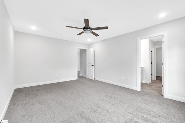 carpeted spare room with ceiling fan