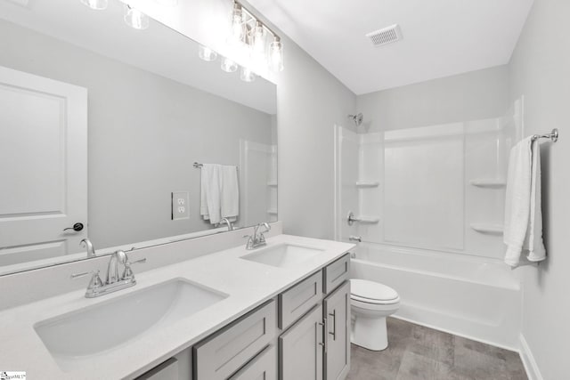 full bathroom with tile patterned floors, double sink vanity, toilet, and shower / bathtub combination