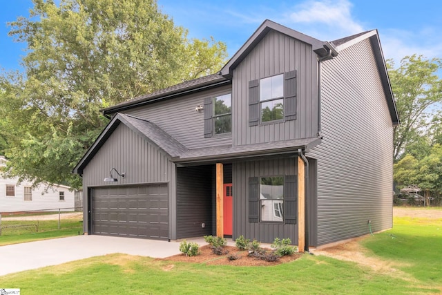 view of front of property with a garage and a front yard