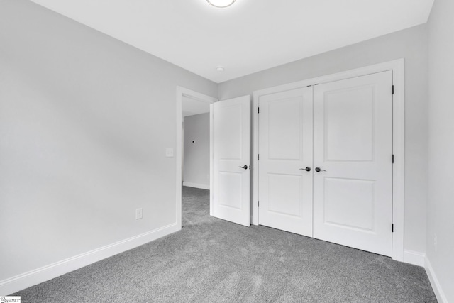 unfurnished bedroom featuring carpet flooring and a closet