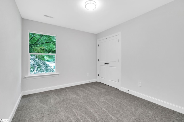 empty room with dark carpet