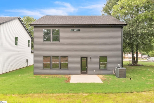 back of property featuring cooling unit, a patio, and a yard