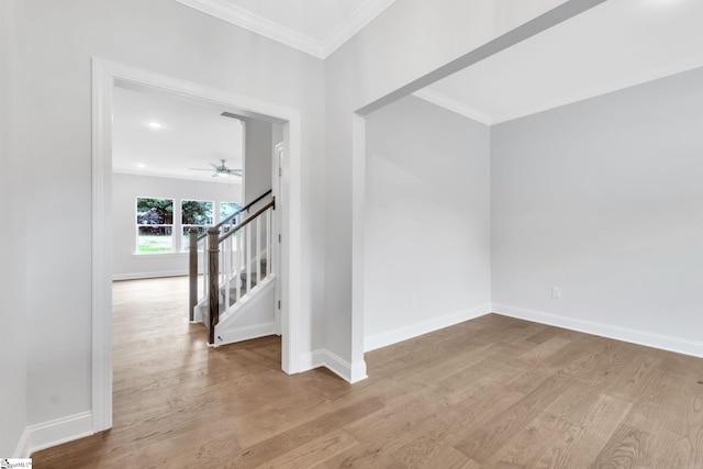 empty room featuring hardwood / wood-style flooring, crown molding, and ceiling fan