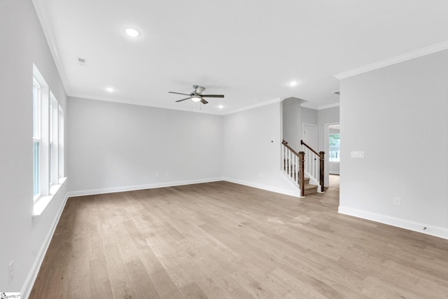 empty room with ceiling fan, ornamental molding, and light wood-type flooring