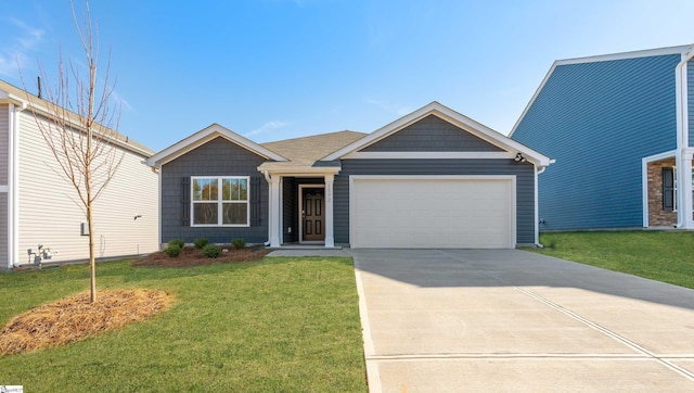 view of front of home featuring a front yard and a garage